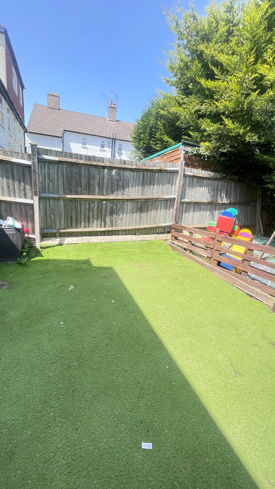 Clean backyard with artificial grass after household waste clearance