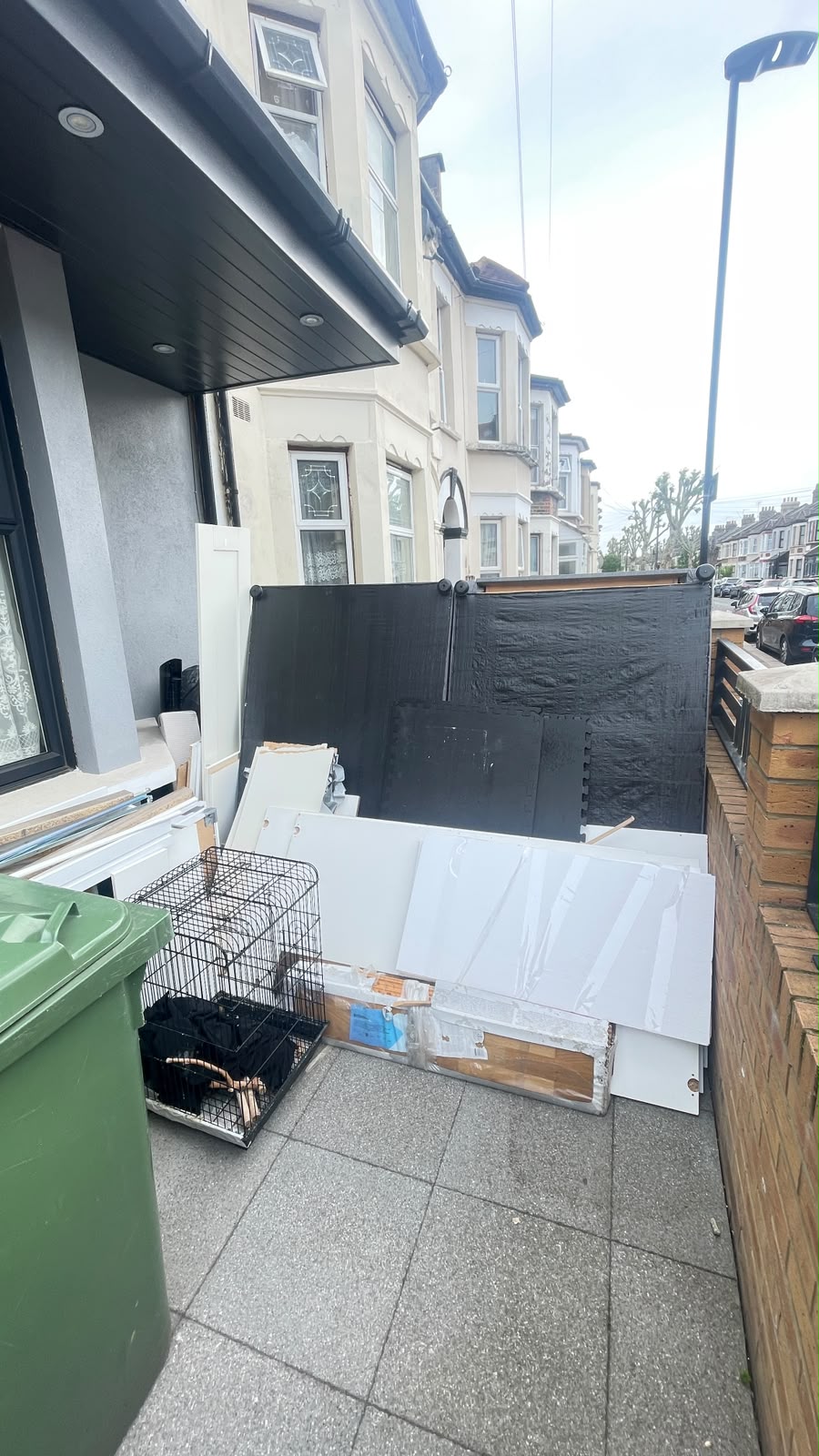 Patio area with discarded items before garden clearance