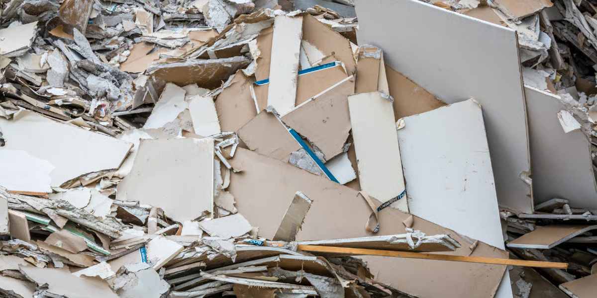 Broken plasterboard sheets and insulation material
