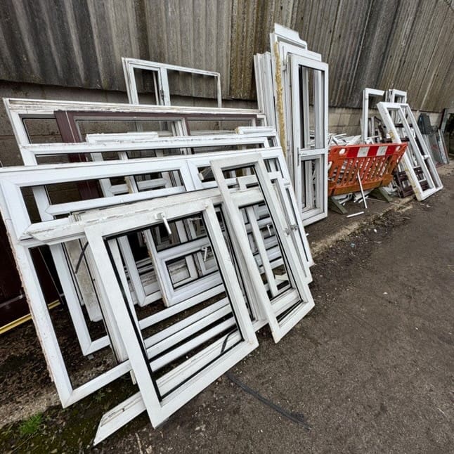 Stacked window frames and glass panes from a renovation