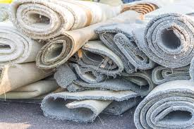 Stack of rolled-up old carpets