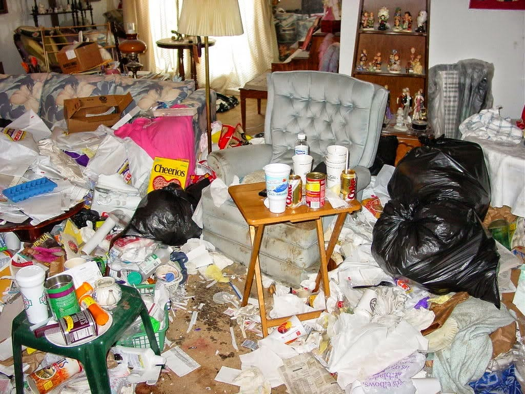 Room filled with verminous household rubbish