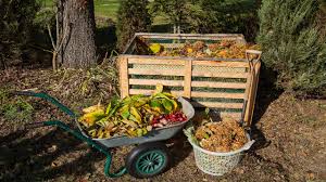 Wheelbarrow beside a compost area in a garden