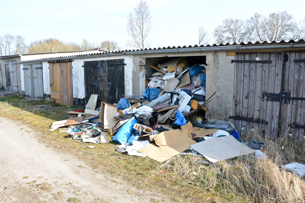 Garage or shed overflowing with junk and storage boxes